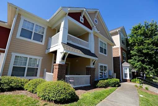 A two-story apartment building with a red and beige exterior.