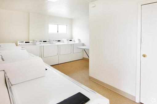 Laundry room with washers and dryers.