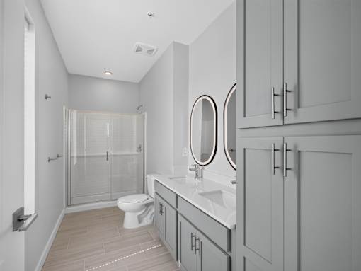 A white bathroom with a toilet, sink, and mirror.