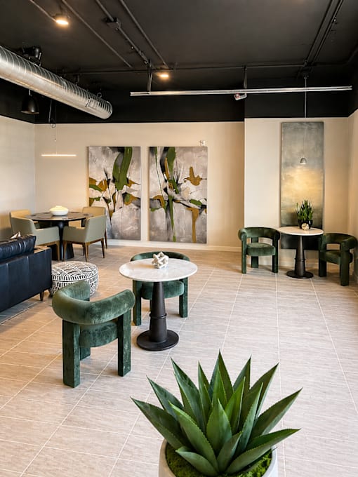 Resident lounge at 200 Main Kannapolis featuring comfortable seating, café tables, and modern gathering spaces for residents.