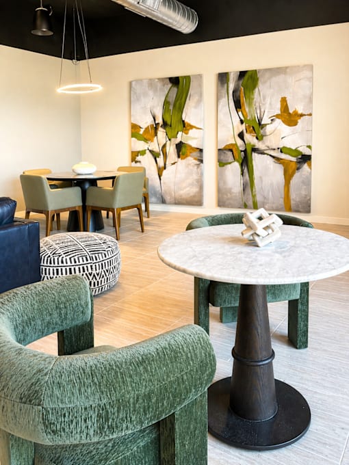 Stylish resident lounge at 200 Main Kannapolis with café seating, designer furnishings, and inviting community spaces.