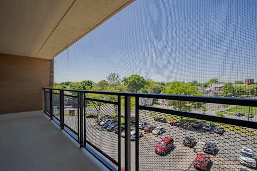 a balcony with a view of a parking lot