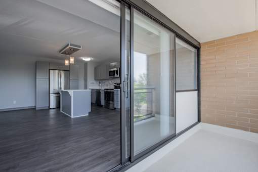 an empty living room with a balcony