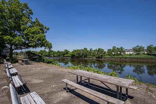 a picnic table next to a body of water