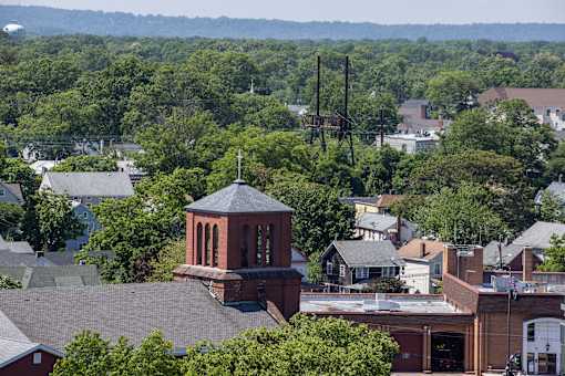 an aerial view of a city with a church tower