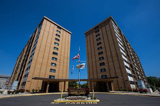 two tall buildings with the flag in front of them
