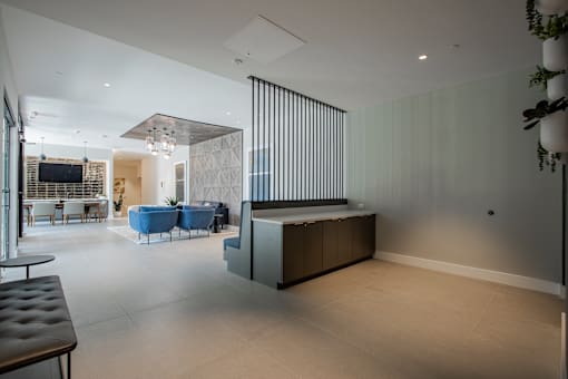 Lobby view at The Rail with seating and divider wall, highlighting design-forward amenity space in this luxury pet-friendly apartment community.