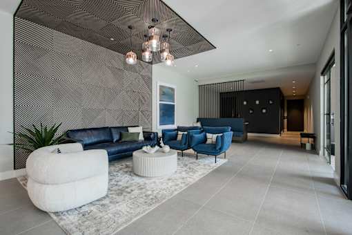 Lobby view at The Rail with seating and divider wall, highlighting design-forward amenity space in this luxury pet-friendly apartment community.