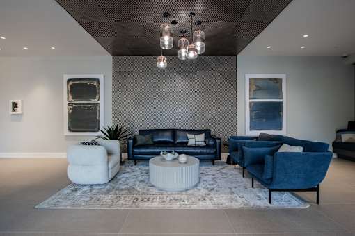 A luxury modern apartment lobby with a blue couch at The Rail at Bound Brook, NJ.