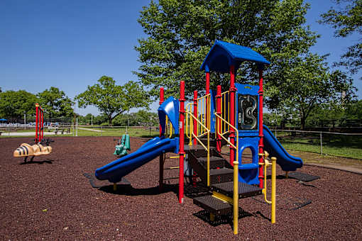 a playground with a blue and red play set