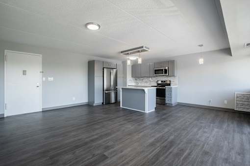 an empty living room and kitchen in an empty apartment