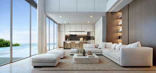 A modern living room with a large window overlooking the ocean.