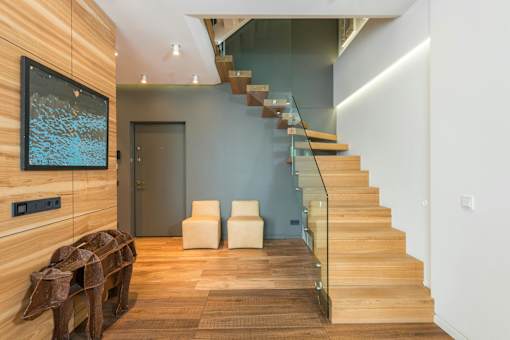 A modern interior with a staircase and a wooden wall.