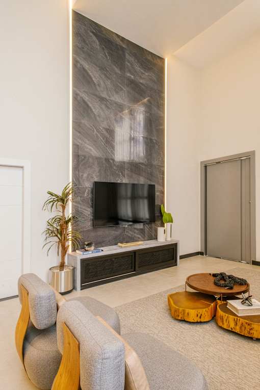 a living room with a tv on the wall and a coffee table in front of it