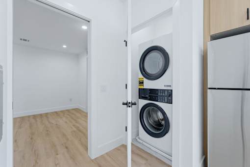 A white door is open to a laundry room.