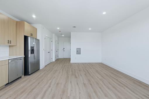 A kitchen with wooden floors and white walls.