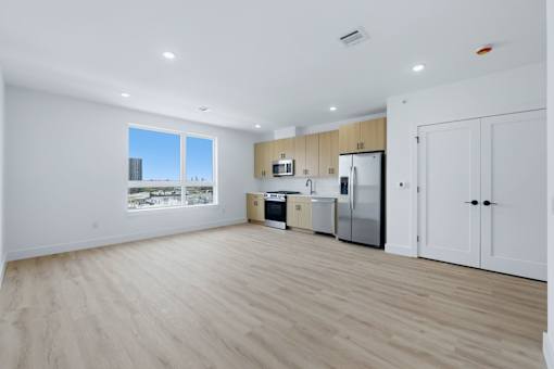 A kitchen with wooden floors and white walls.