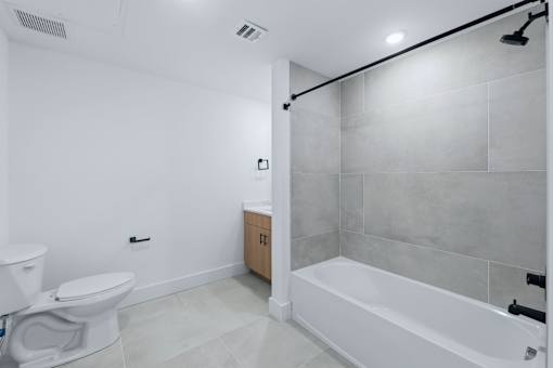 A white toilet and sink in a bathroom.