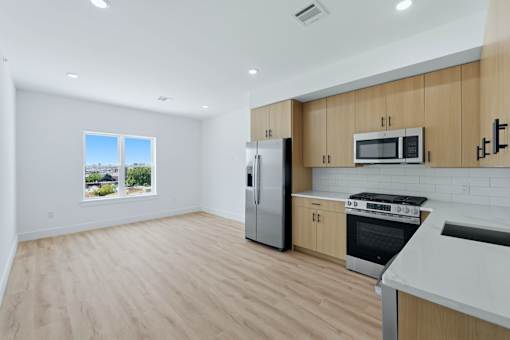 A kitchen with wooden cabinets and stainless steel appliances.