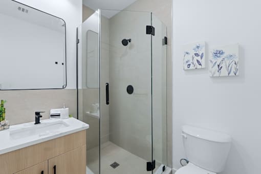 A white toilet sits next to a sink in a bathroom.
