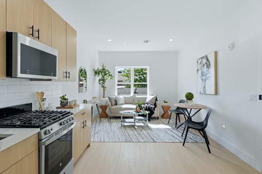 A modern kitchen with a black stove top oven and a microwave above it.