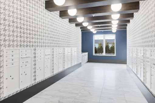 A hallway with lockers on both sides and a window at the end.