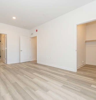 A room with a wooden floor and white walls.