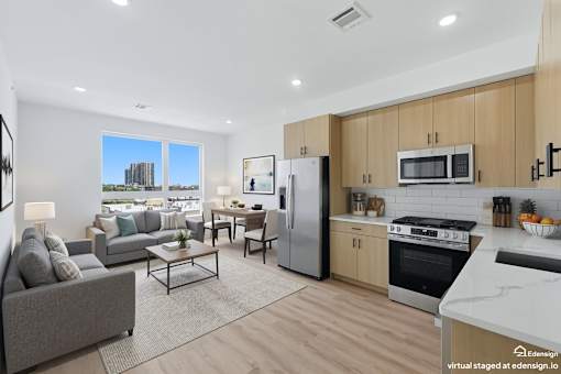 A modern kitchen with wooden cabinets and stainless steel appliances.
