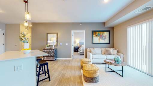 A living room with a white couch and a wooden floor.