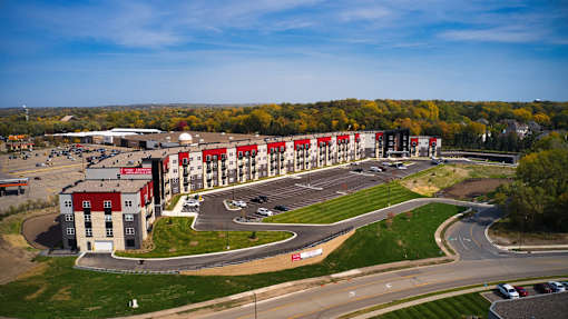 A large building with a parking lot in front of it.