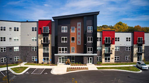 Apartment complex with the name "ARRIYS" on the front building.
