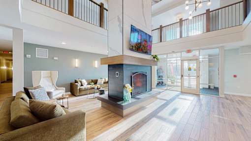A living room with a fireplace and a television.