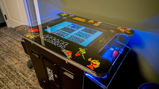 A pinball machine with a black background and colorful designs.