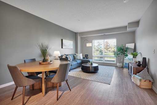 A modern dining room with a wooden table and chairs.