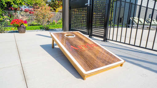 A shuffleboard table with red letters on it.
