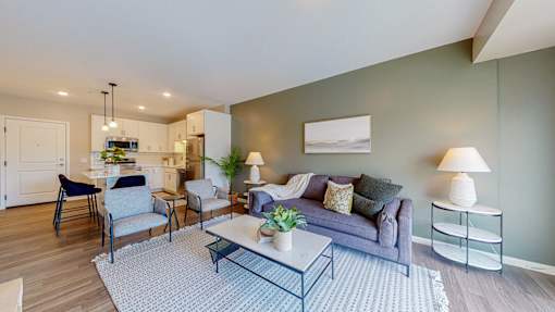 A modern living room with a grey couch and a coffee table.