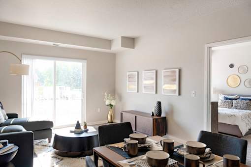 A modern living room with a dining table set for four.