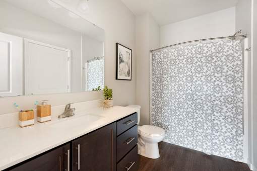 A bathroom with a white sink and a toilet.