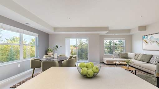 A dining table with a bowl of green apples on it.