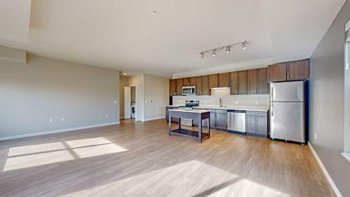 A kitchen with a wooden counter top and stainless steel appliances.