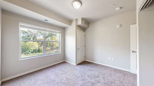 A room with a window and a door.