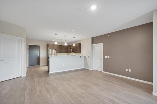 A spacious room with a white reception desk and a brown wall.
