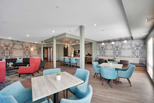 A dining room with blue chairs and a wooden table.