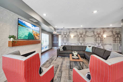 A modern living room with a flat screen TV mounted on a brick wall.