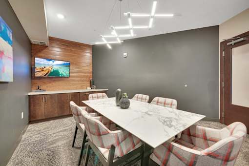 A conference room with a long table and chairs.