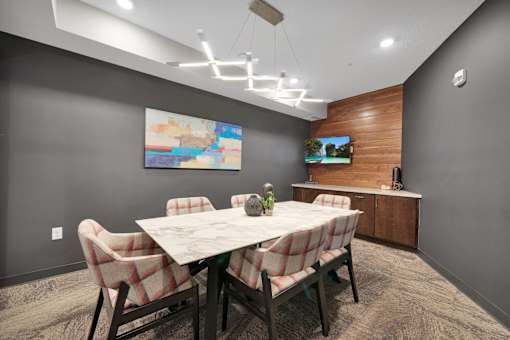 A dining room with a table set for four.