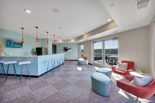 A modern living room with a bar area and comfortable seating.