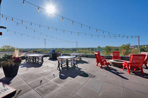 A sunny day at an outdoor seating area with tables and chairs.