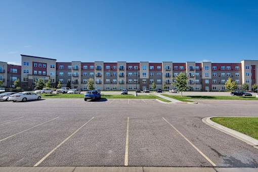 A parking lot with a building in the background.