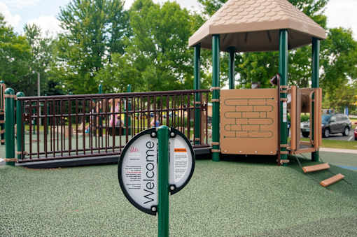 A playground with a sign that says "Welcome".